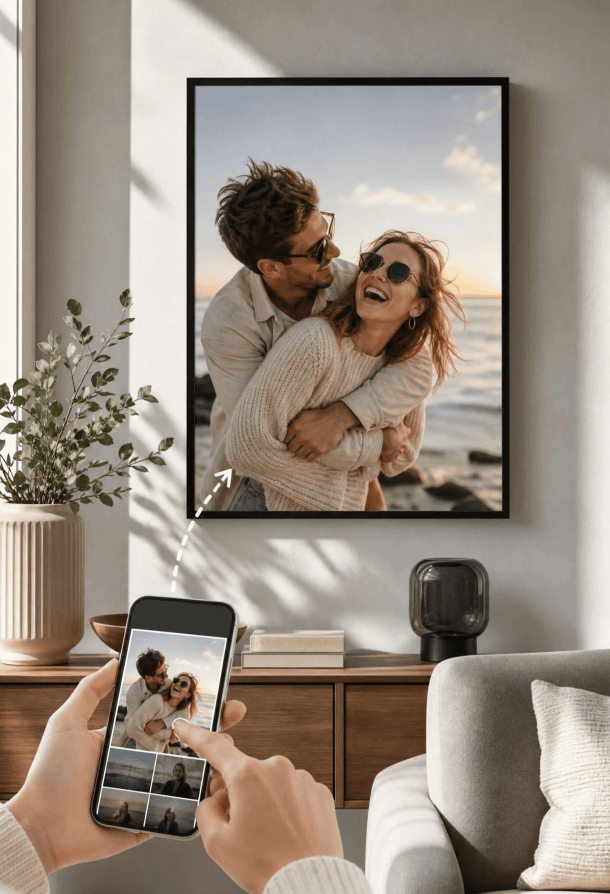 Hands holding a phone turning a couple photo into a framed wall poster in a sunlit living room